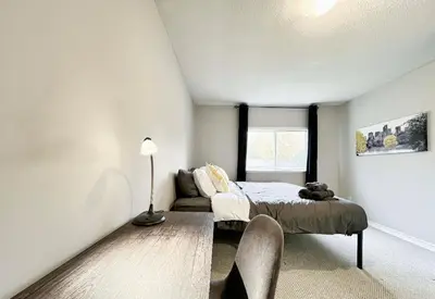 a bedroom with a bed and a couch and a window at Canada WonderLand Stay-Superb Location in Vaughan