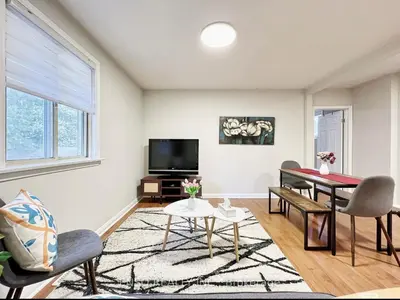 a living room with a table and chairs and a tv at Canada WonderLand Stay-Superb Location in Vaughan