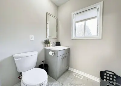 a bathroom with a toilet and a sink and a window at Canada WonderLand Stay-Superb Location in Vaughan
