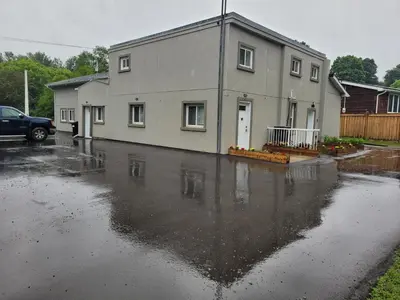 a house sitting on top of a flooded parking lot at Sartawi Place -Studio at Georgian Bay in Waubaushene