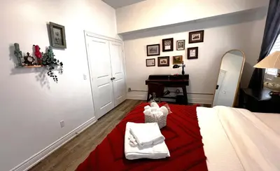 a bedroom with a bed with a red blanket at The Downtown Gem Toronto in Toronto