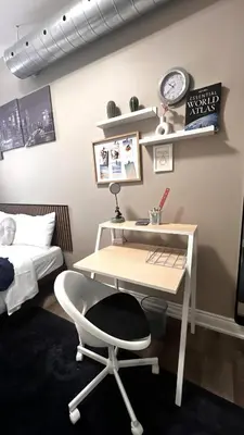 a desk and a chair in a room with a bed at The Downtown Gem Toronto in Toronto