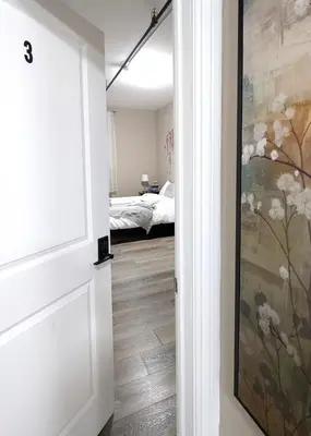 a hallway with a painting on the wall and a bedroom at The Downtown Gem Toronto in Toronto