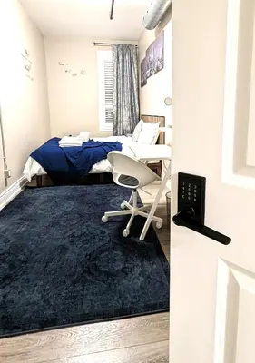 a bedroom with a bed and a desk and a chair at The Downtown Gem Toronto in Toronto