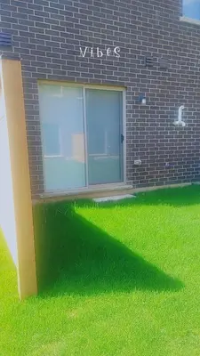a window on the side of a brick building at Comfortable Getaway in Hamilton
