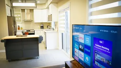 a kitchen with a view of a kitchen with a counter at Stunning fully furnished detached house 4 Bed Retreat, with complete privacy and comfort, WiFi & Full Kitchen in Paris