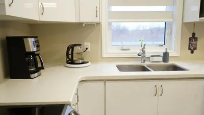 a kitchen with a sink and a coffee maker at Stunning fully furnished detached house 4 Bed Retreat, with complete privacy and comfort, WiFi & Full Kitchen in Paris