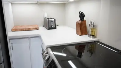 a kitchen with a counter with a sink and a stove at Stunning fully furnished detached house 4 Bed Retreat, with complete privacy and comfort, WiFi & Full Kitchen in Paris