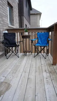 two chairs and a table on a wooden deck at Stunning fully furnished detached house 4 Bed Retreat, with complete privacy and comfort, WiFi & Full Kitchen in Paris