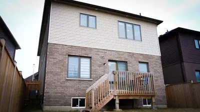 a house with a wooden deck in front of it at Stunning fully furnished detached house 4 Bed Retreat, with complete privacy and comfort, WiFi & Full Kitchen in Paris