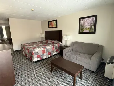 a hotel room with a bed and a couch at Fort York Motel in Mississauga