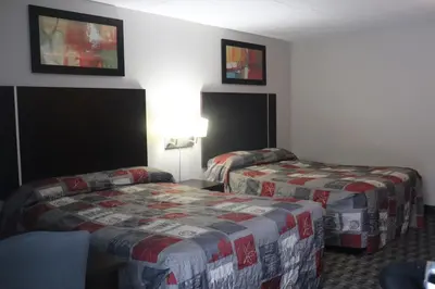 a hotel room with two beds in a room at Fort York Motel in Mississauga