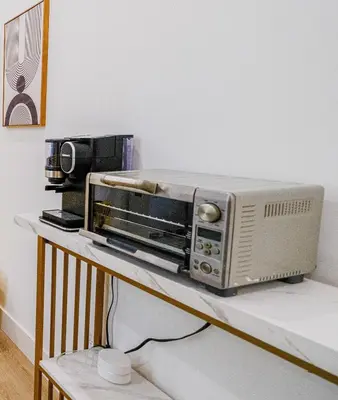 a toaster oven sitting on top of a counter at Adorable Modern Master Bedroom near Colleges and K-town in Toronto