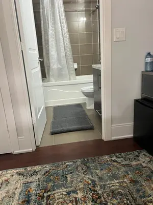 a bathroom with a tub and a toilet and a shower at Cozy Ensuite private room homestay in Mississauga
