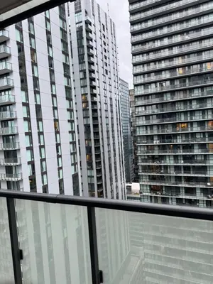 a view of some tall buildings from a window at Cozy 1 Bedroom Downtown in Toronto