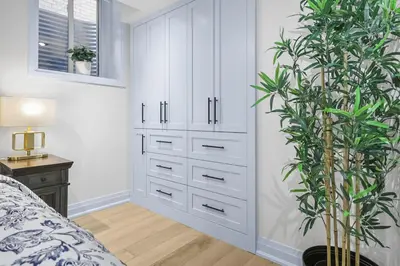a bedroom with white cabinets and a potted plant at Pinnacle of Luxury & Leisure- 2 BDM,2 BATH, KITCHEN in Whitby