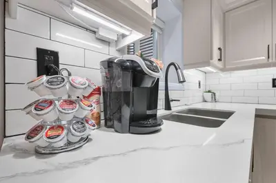 a coffee maker and cups on a kitchen counter at Pinnacle of Luxury & Leisure- 2 BDM,2 BATH, KITCHEN in Whitby