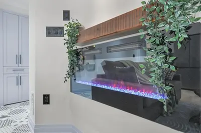 a living room with a fire place in a wall at Pinnacle of Luxury & Leisure- 2 BDM,2 BATH, KITCHEN in Whitby
