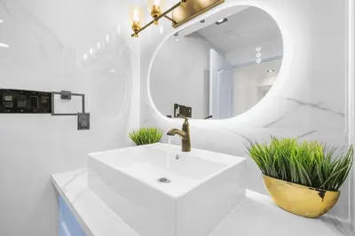 a white bathroom with a sink and a mirror at Pinnacle of Luxury & Leisure- 2 BDM,2 BATH, KITCHEN in Whitby