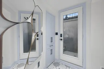 a hallway with two windows and a mirror at Pinnacle of Luxury & Leisure- 2 BDM,2 BATH, KITCHEN in Whitby