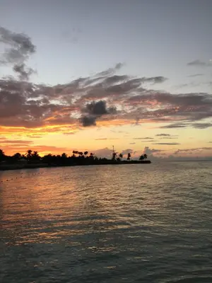 an island in the middle of the water at sunset at Spacious Beach Town Retreat - Sleeps 8 in Port Elgin