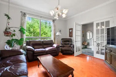 a living room with a leather couch and a table at Spacious Beach Town Retreat - Sleeps 8 in Port Elgin