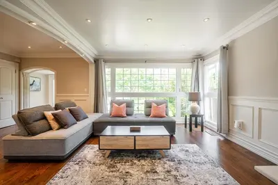 a living room with a couch and a table at 3 Bedroom Luxury House in Toronto in Toronto