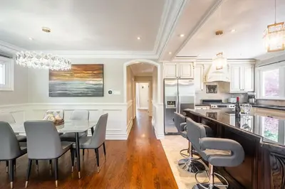 a kitchen and dining room with a table and chairs at 3 Bedroom Luxury House in Toronto in Toronto