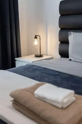 a hotel room with a bed with towels on it at Modern 1BR and 1BA condo near Downtown with City Views in Toronto