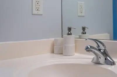 a bathroom sink with a faucet and a mirror at Chic 1BR Condo Lake and City Views plus Free Parking in Toronto