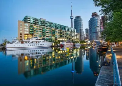 a city skyline with a boat in the water at Chic 1BR Condo Lake and City Views plus Free Parking in Toronto