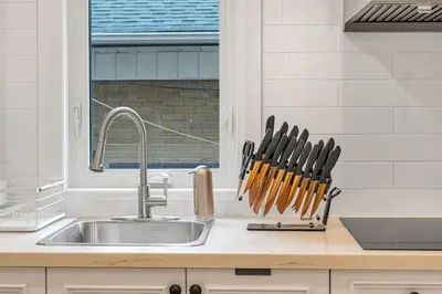 a kitchen counter with a sink and a knife rack at Cozy 2BR Home with Workspace Toronto Retreat in Toronto