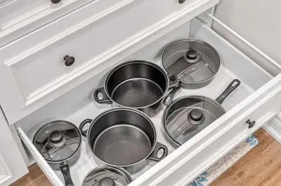 a bunch of pots and pans in a kitchen drawer at Cozy 2BR Home with Workspace Toronto Retreat in Toronto