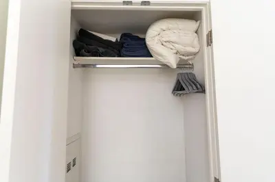 a closet with a drawer filled with clothes at Chic 1BR plus Den Condo Near ROM and CN Tower in Toronto