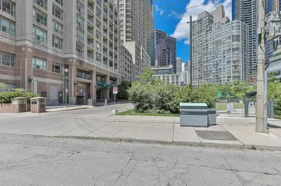 a empty street in a city with tall buildings at Cozy 1BR Condo with Balcony and Parking in Toronto