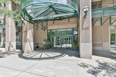 an entrance to a building with a glass door at Cozy 1BR Condo with Balcony and Parking in Toronto