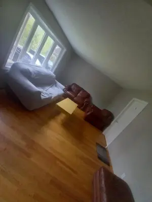 an attic room with a bed and a window at Homestay Near Victoria Park- FREE WIFI & PARKING-TOP LOCATION in Kitchener