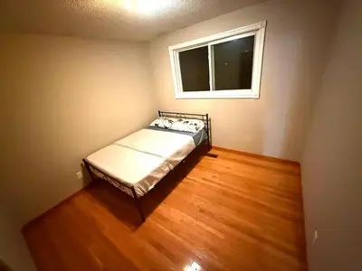 a small bedroom with a bed and a window at Homestay Near Victoria Park- FREE WIFI & PARKING-TOP LOCATION in Kitchener