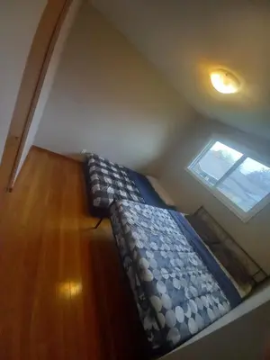 a bed in a room with a window at Homestay Near Victoria Park- FREE WIFI & PARKING-TOP LOCATION in Kitchener