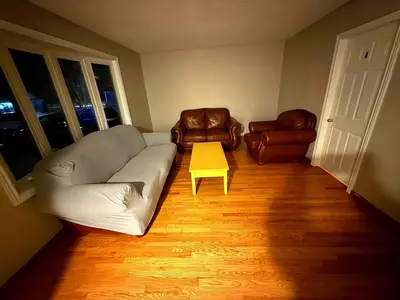 a living room with a couch and two chairs at Homestay Near Victoria Park- FREE WIFI & PARKING-TOP LOCATION in Kitchener
