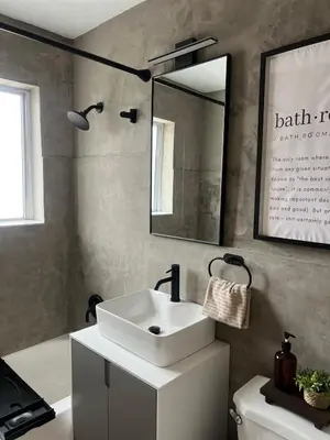 a bathroom with a sink and a mirror and a tub at Cozy Bohemian Apartment in Toronto