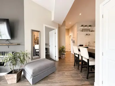 a kitchen and dining room with a table and chairs at Contemporary West Loft in Historic Niagara in Niagara on the Lake