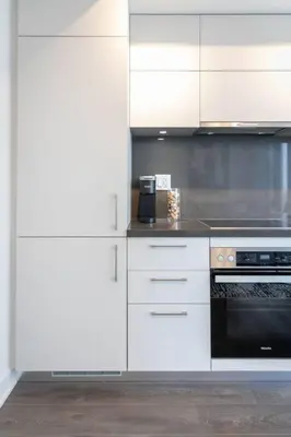 a kitchen with white cabinets and a black oven at Executive 1BR-1BA Condo in the heart of downtown in Toronto
