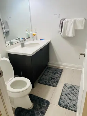 a bathroom with a toilet and a sink at The Residence, Your comfort is our culture in Oakville