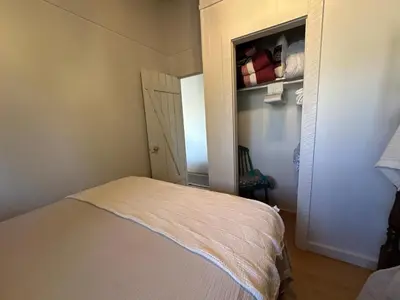 a room with a bed and a closet with a door at Cozy lakeside Cottage on 3 Mile Lake with Wifi in Windermere