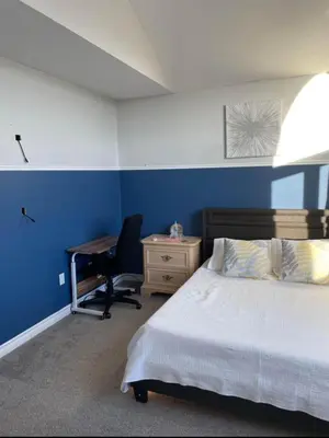 a bedroom with a bed and a desk and a chair at Serene Bedroom with Private Ensuite in Georgina