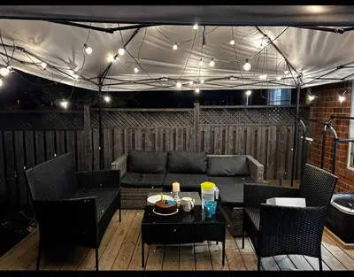 a patio with a couch and a table with chairs at The Sleek Shelter in Milton