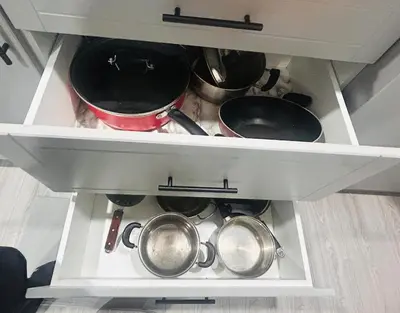 a drawer full of pots and pans in a kitchen at The Sleek Shelter in Milton