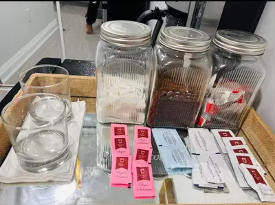 a table with jars of food and drinks on it at The Sleek Shelter in Milton