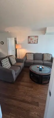 a living room with a couch and a coffee table at Lovely condo near Lake Ontario in Toronto